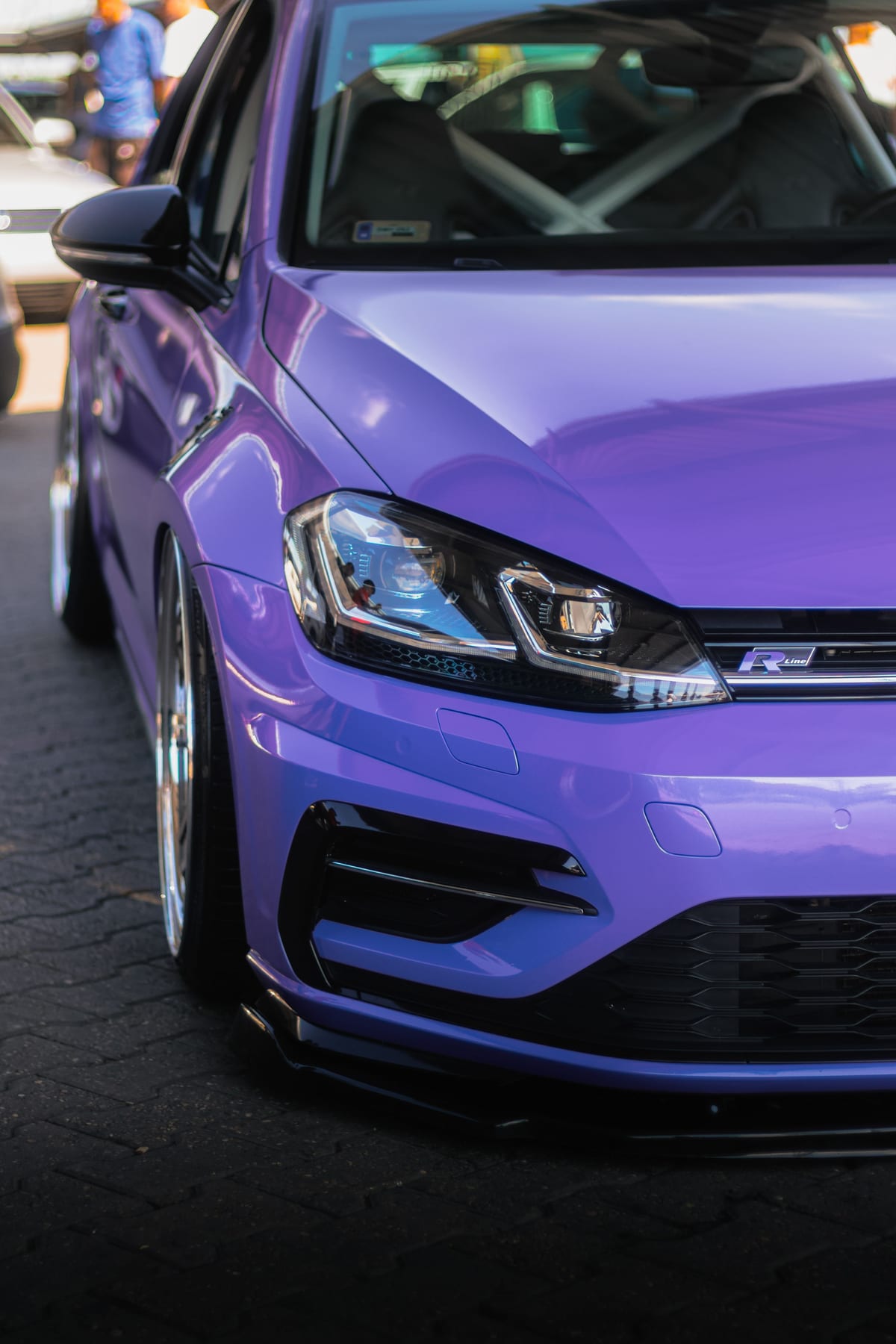 Front three-quarter of a purple car with a deep gloss finish